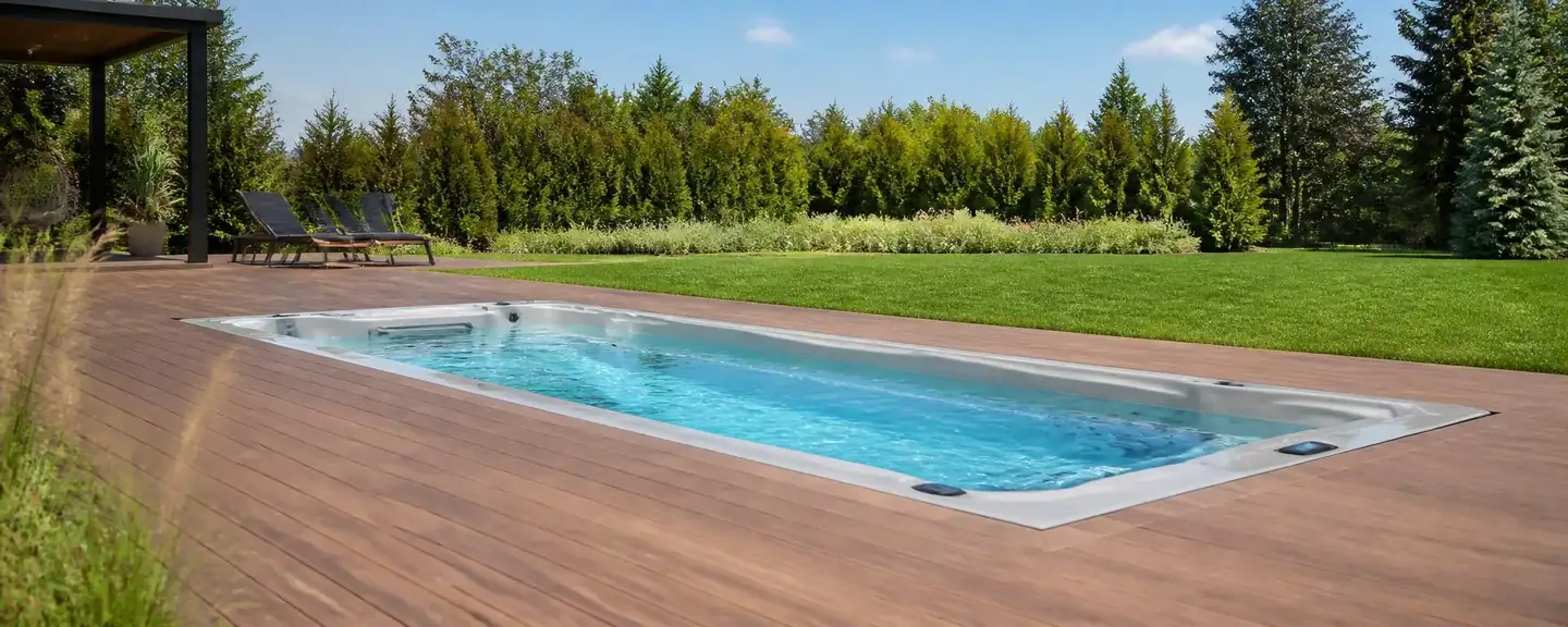 Recessed swim spa in a sunny modern backyard deck